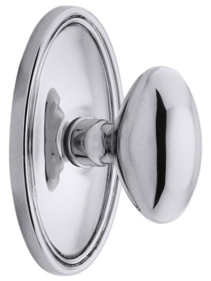 Oval Rosette Set With Elliptical Brass Knobs in Polished Chrome.